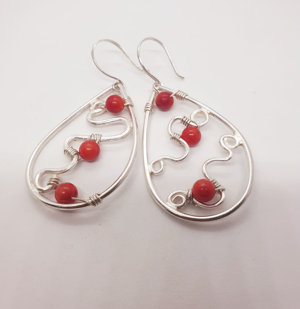 Teardrop shaped silver earring with red amber inside-1
