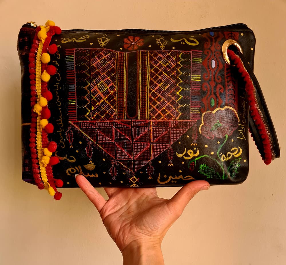 Handpainted faux leather black clutch with tatreez pattern and Arabic phrases 