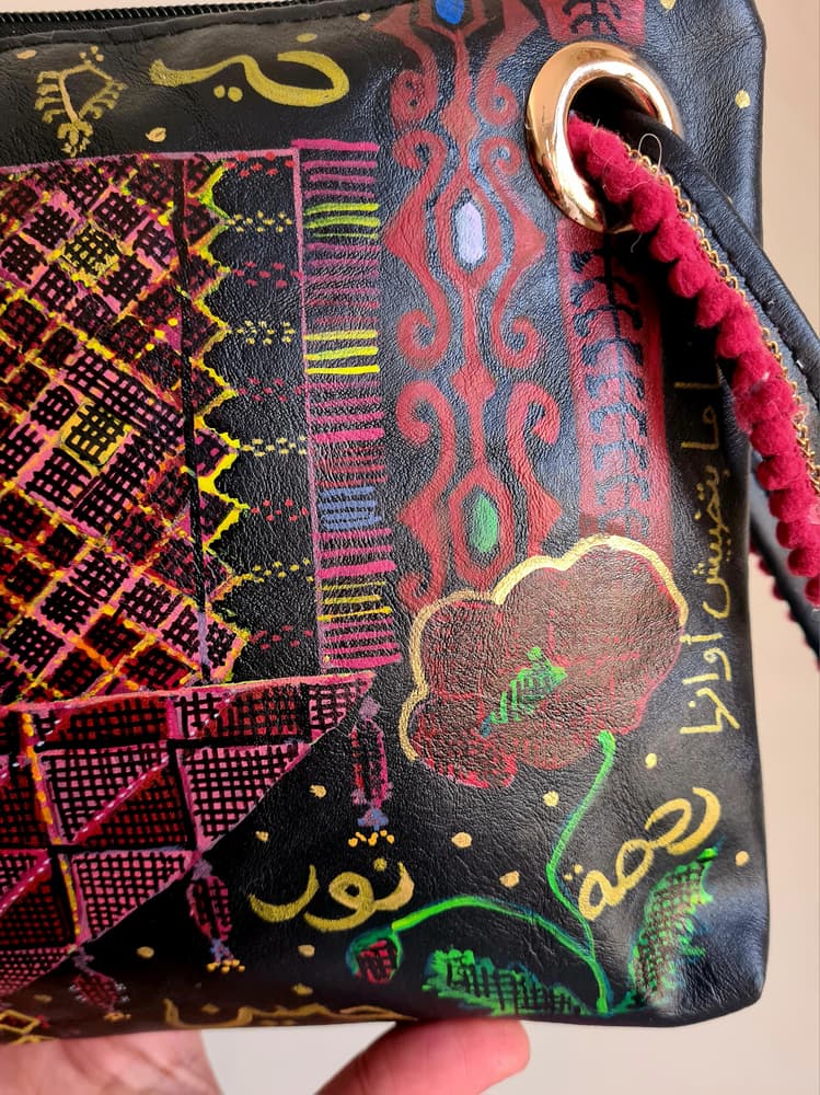 Handpainted faux leather black clutch with tatreez pattern and Arabic phrases 